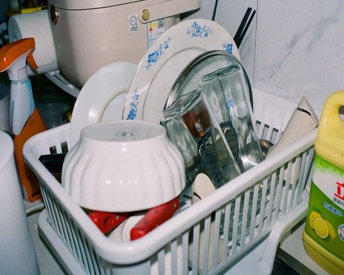 person cleaning the kitchen after a meal